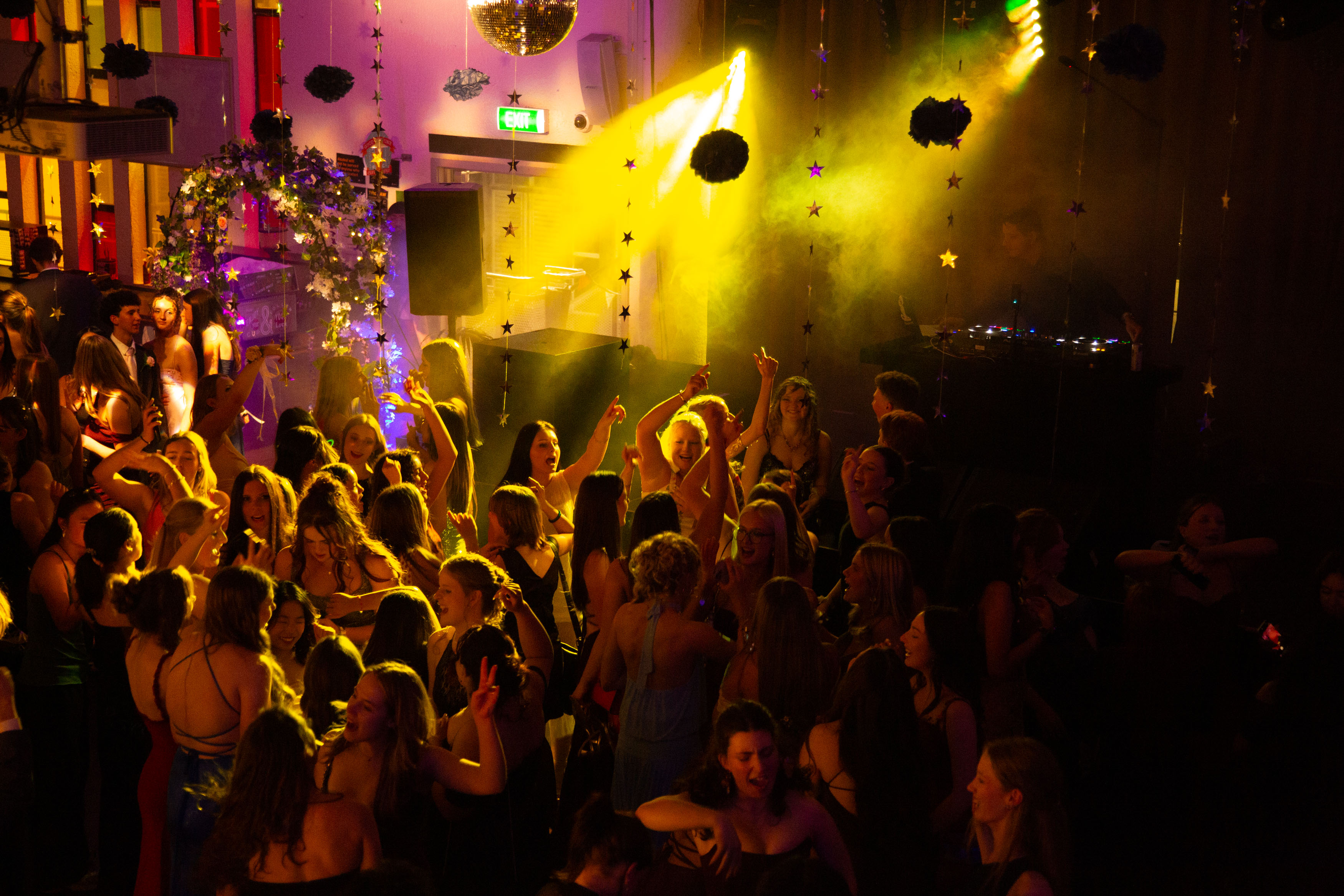 Crowd dancing at a bar under the lights